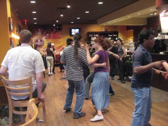 People Swing Dancing in a Coffee Shop